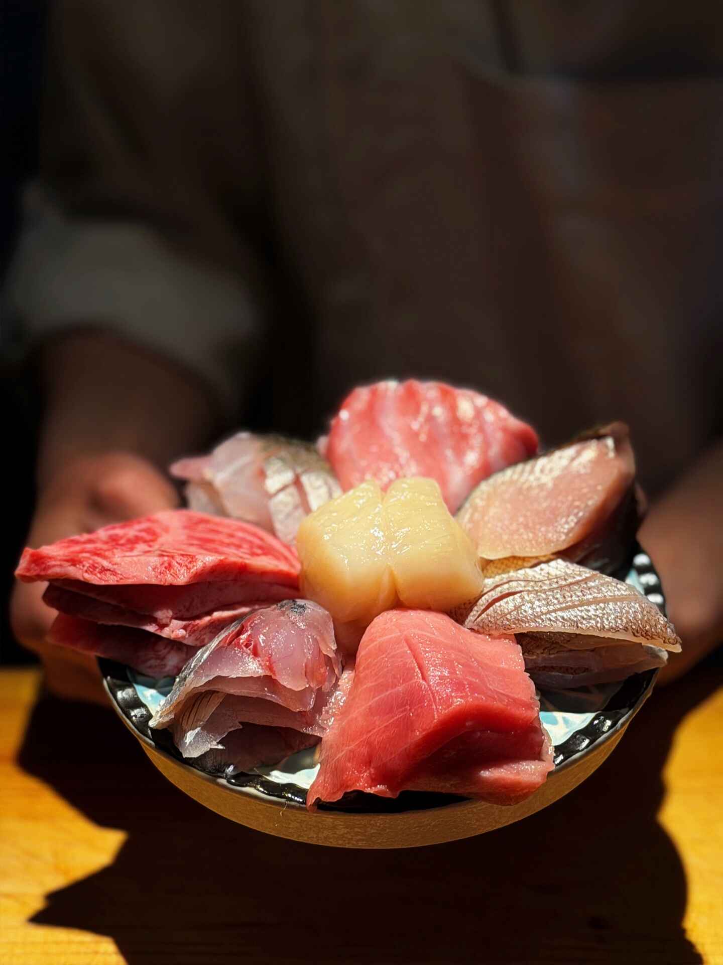 A seasonal fish course served in Japanese ceramic tableware